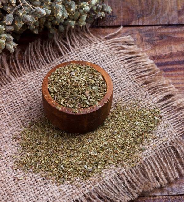 Bunch of organic dry oregano on old wooden background